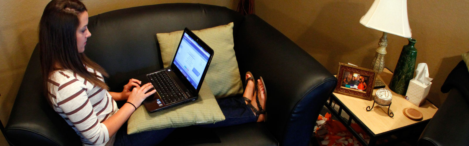 Student on a couch with a laptop